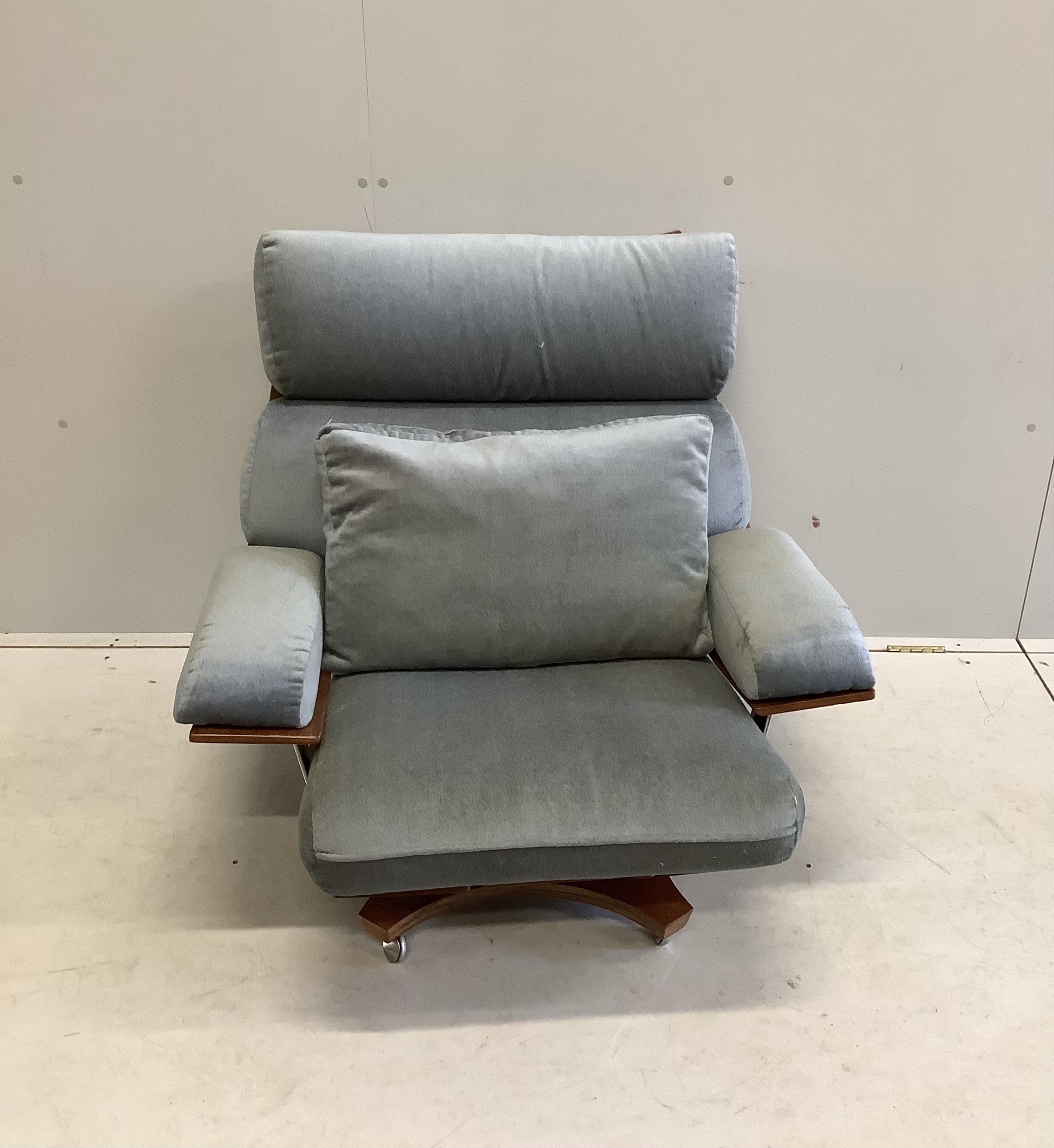 A mid century G Plan Housemaster teak swivel armchair with pale blue loose cushions, width 88cm, depth 66cm, height 81cm. Condition - fair to good